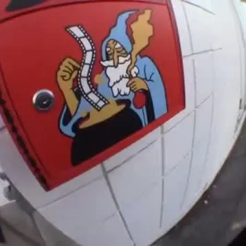 Fisheye shot of the painted wizard on the shop wall, from the film restock reel
