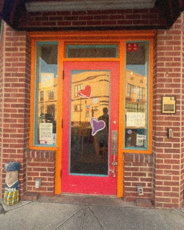 The Naomi Market storefront with its red door